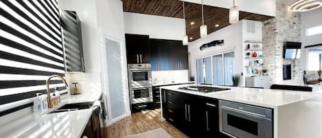 Kitchen view, Thermador appliances, double oven and Murphy Door, Pantry.