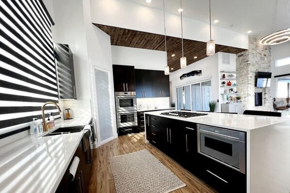 Kitchen view, Thermador appliances, double oven and Murphy Door, Pantry.