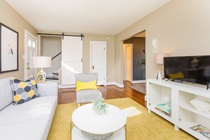 The living room connects to the dining room and loops around into the kitchen. 