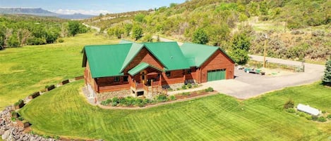 Enjoy a lush, well-maintained lawn at this quiet, luxury log home