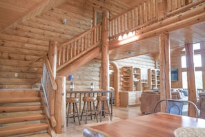 Note three barstools at the table by the stairs, for total dining seating of 14.