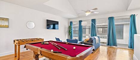 Full-size pool table and foosball table included.