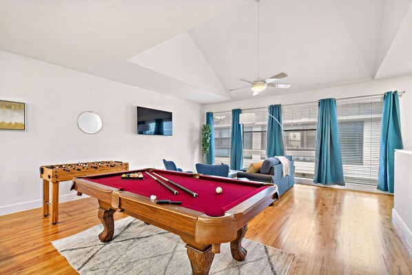 Full-size pool table and foosball table included.