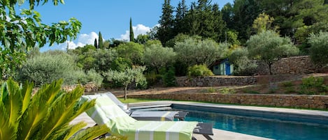 Piscine chauffée de 12 x 4 m avec plage en travertin et douche extérieure