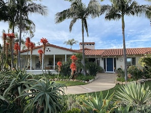 The front entrance w/ single-story living for the main home.