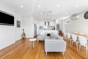 The home’s open layout and expansive windows fill the space with natural light, creating a warm and welcoming atmosphere