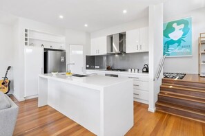 Open plan living, kitchen and dining area make the most of the lake views
