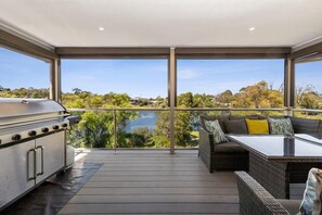 The BBQ and outdoor seating area are ideal for enjoying meals while taking in the stunning scenery