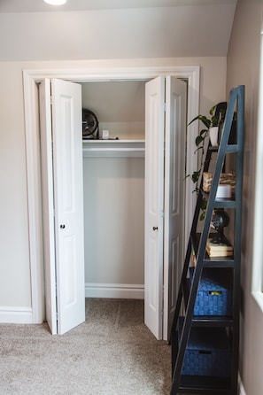 Closet that includes fan, iron, ironing board, etc.