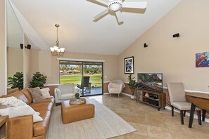 Spacious living room with plenty of seating and smart T.V. 