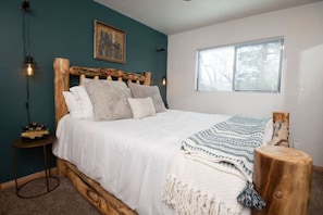 Master bedroom, this room has black out blinds (added after photo), a full-length mirror closest and a private attached bathroom. Sleep in after sunrise in the peace and quiet or open the shades up to watch the snow fall in the wintertime- Rather Be Prope