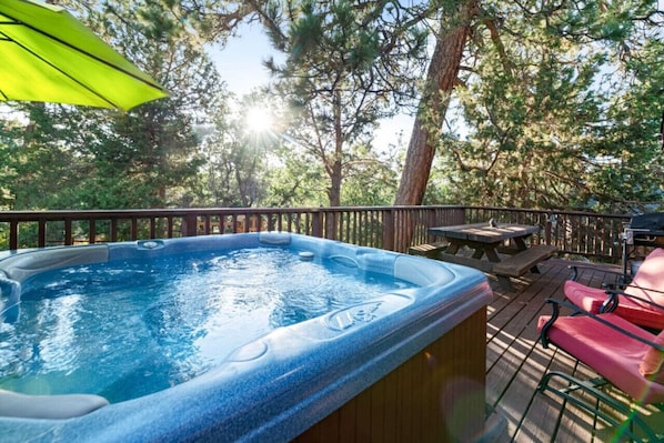 Indulge in luxury as you soak the hot tub amidst nature's beauty. Your tranquil escape awaits.