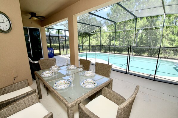 Large pool covered patio nature view.