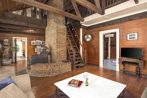Exposed wooden beams and brick fireplace