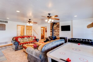 Basement Living Room. Air Hockey, Foosball, Darts, Games. Wood-burning fire. TVs