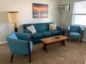 Living area w/ AC/Heat, 46" flat screen Smart TV, Carpet, leads out to porch