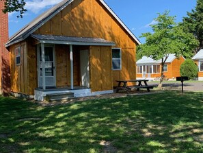 This is the back porch with picnic table, BBQ grill, fire pit. 