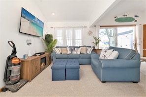 Living room entry way featuring electric fireplace and smart tv