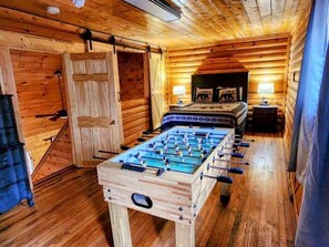 Upstairs loft:  Queen bed with foosball.  Keep scrolling to see the large area that also has bunk beds, sitting area, flat screen TV, games, and books.  We take pride in having everything a family needs.  This is a cabin with both comfort and fun in