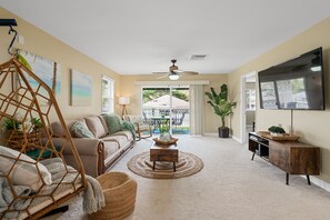 Living room with 65" HD Smart TV and Lanai