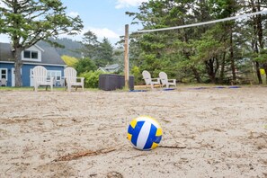 Play a game of beach volleyball in the communal court.