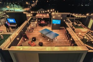 Enjoy some ping pong, TV, and cornhole on Elvis' rooftop!