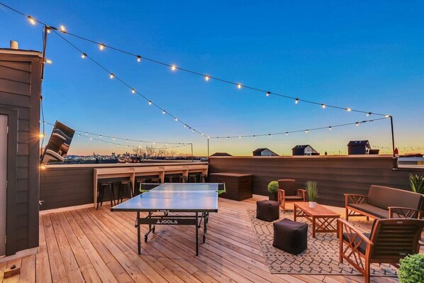 Enjoy some ping pong, TV, and cornhole on Elvis' rooftop!