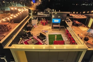 Gather on the roof for games, dinner, and some TV