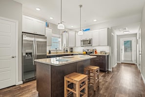Kitchen with Bar Stool Seating on First Level