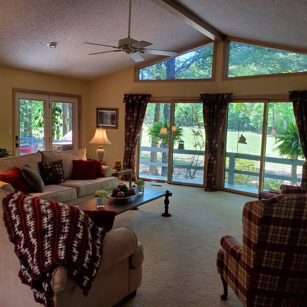 living room overlooking backyard and golf course 