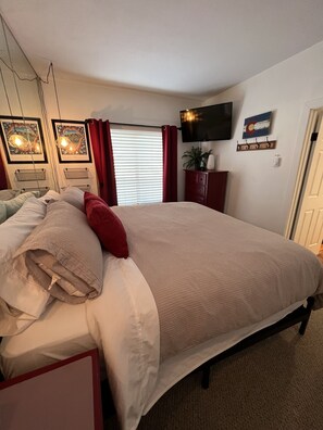 Bedroom with King sized bed and television.