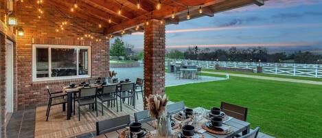 [Resort Property] Covered patio with seating for 16 near gas grill and kitchen area overlooking beautiful views