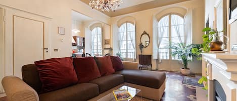 Three large windows illuminate the open plan living, dining room