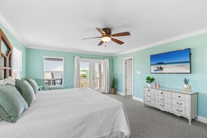 The oversized master bedroom features a king bed, 55 inch television, and access to a private second-story front deck,