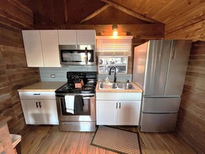 Full kitchen with utensils, pots and pans, coffee maker, and toaster