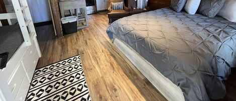 Designer inspired interior.  View from front door.  Luxurious memory foam queen bed, bunk bed with trundle sleeps 5.  Full kitchen with utensils, pots and pans, coffee maker, and toaster.