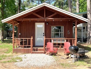 Front porch with swing and chairs.