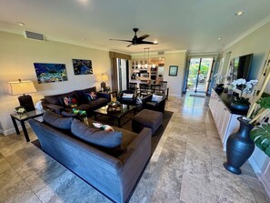 Living room facing towards dining area, kitchen and main entrance