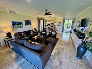 Living room facing towards dining area, kitchen and main entrance