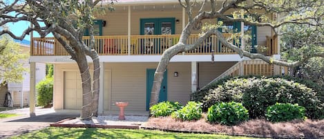 View of the house from the road with the shaded front porch 