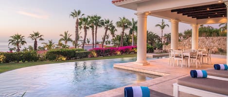 Outdoor Area with an infinity pool and view of the ocean.