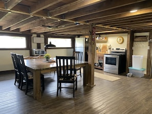 Full kitchen with large dining/game table for gathering. 