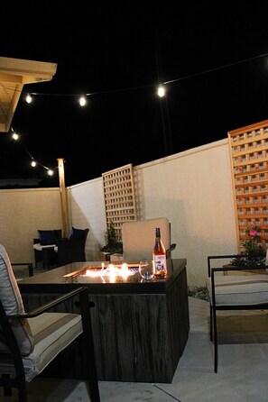  granite-top fire pit plus string light makes the perfect evening ambiance:)