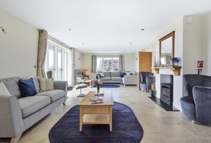 All Views, Burton Bradstock: Sitting room with wood burning stove