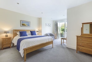 All Views, Burton Bradstock: Bedroom five with a king-size bed and doors to the garden