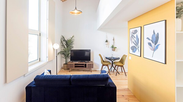 Gorgeous living room with a flat screen TV, cozy sofa and dining area for 2. #comfort #bright