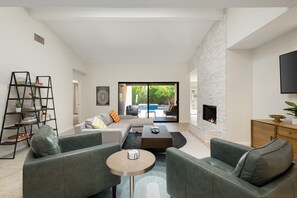 Living room facing out to pool area. 