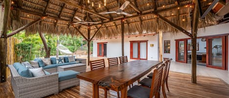 Rancho with dining table, tv, bamboo bar, outdoor sofa sitting area and a BBQ. 