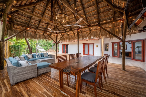 Rancho with dining table, tv, bamboo bar, outdoor sofa sitting area and a BBQ. 