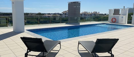 Rooftop swimming pool with two luxury sun loungers for exclusive use